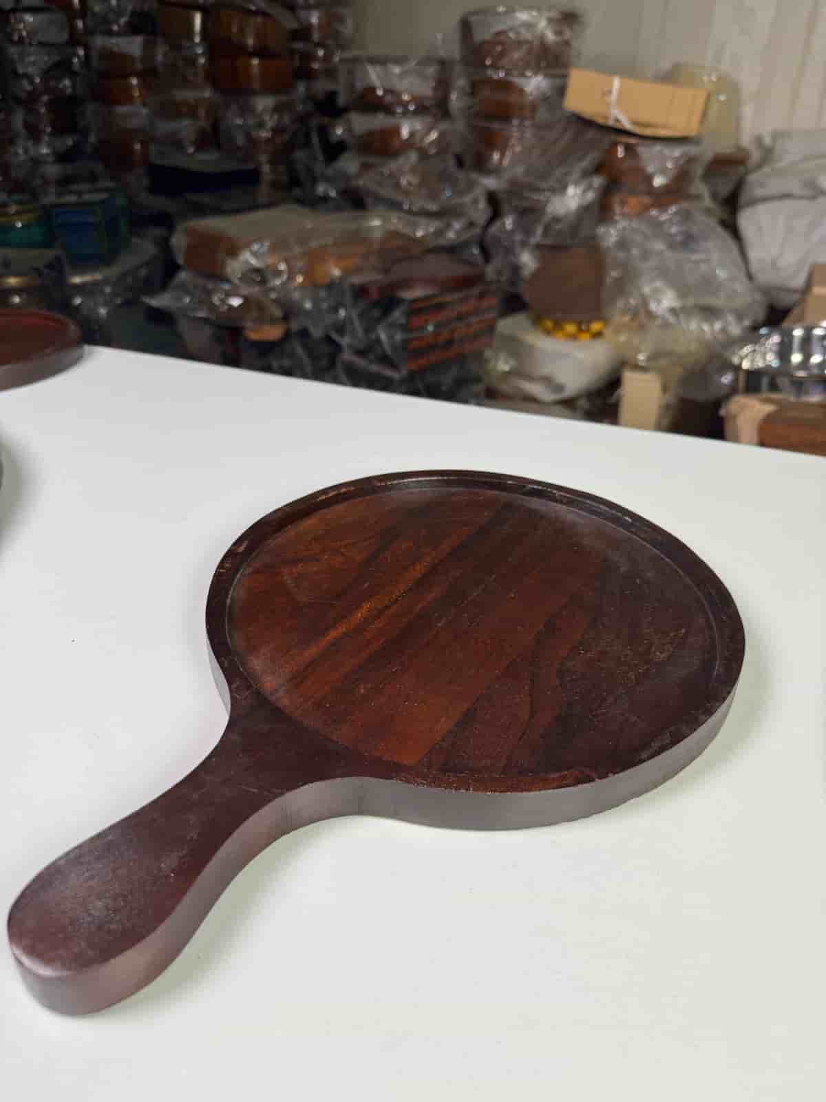 Non-stick pizza pan with handle on a countertop with a freshly baked pizza

