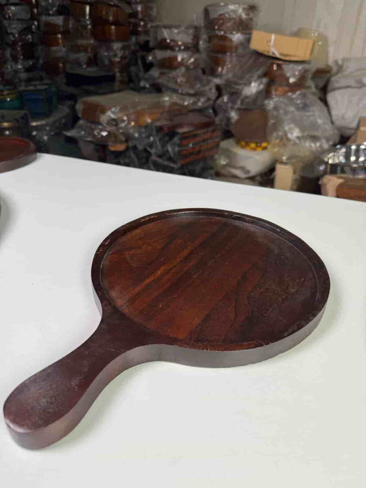 Non-stick pizza pan with handle on a countertop with a freshly baked pizza

